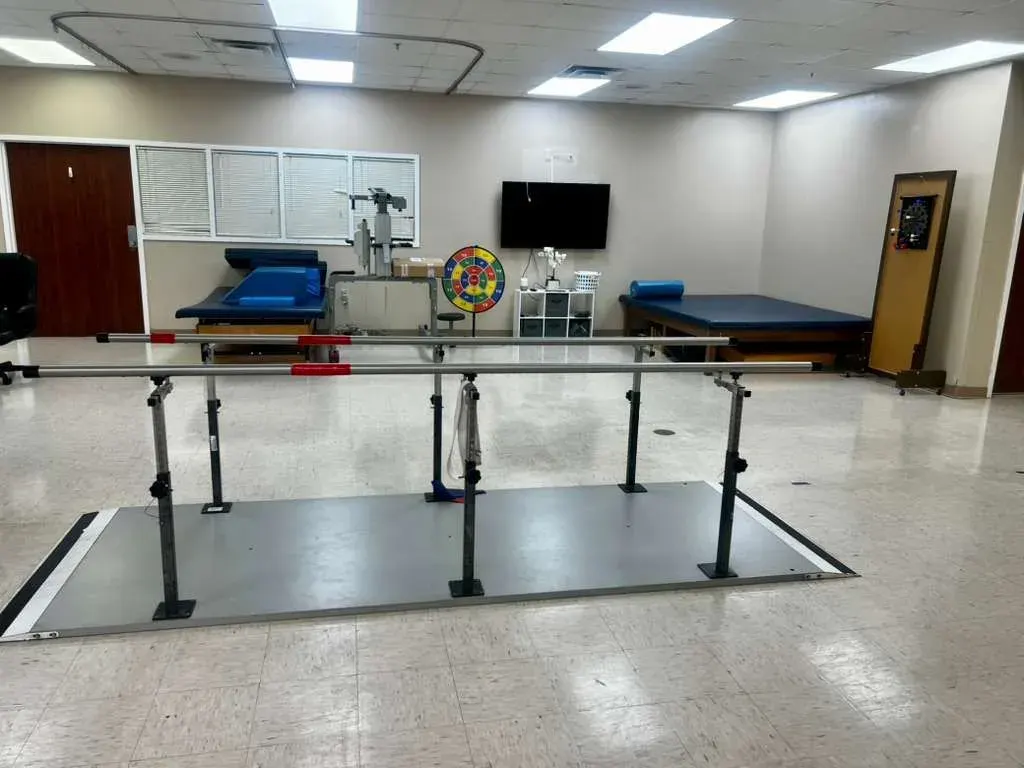 The therapy gym at Vivo Healthcare Meadows, with parallel bars and training stairs