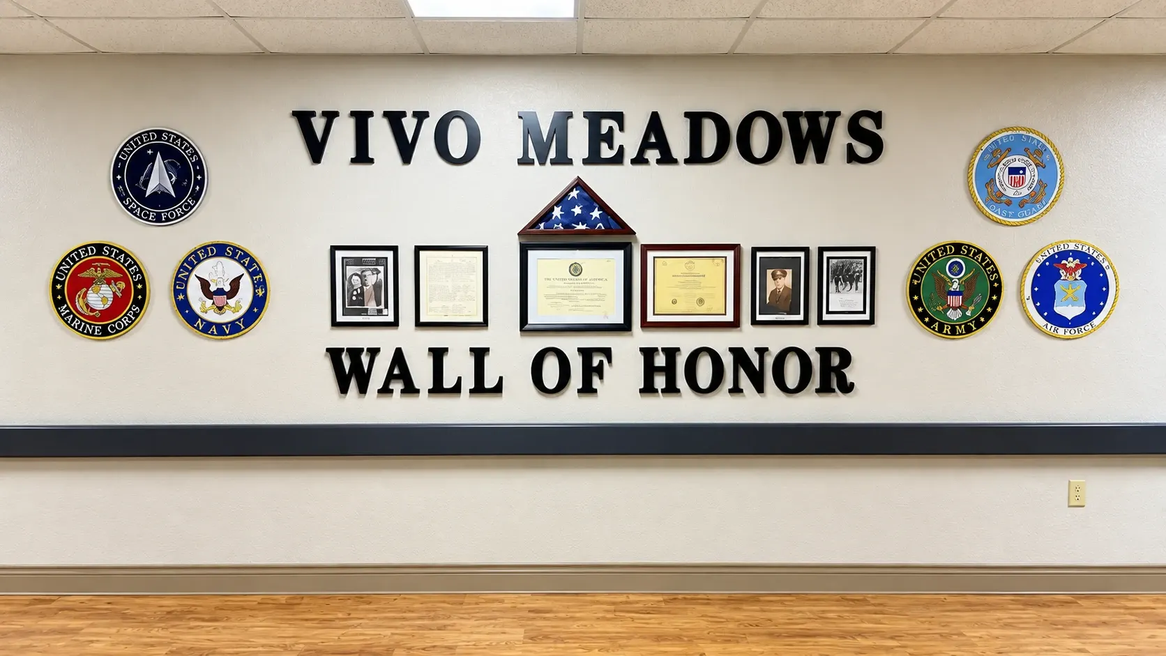 The Wall of Honor at Vivo Healthcare Meadows, with the seals of the armed services